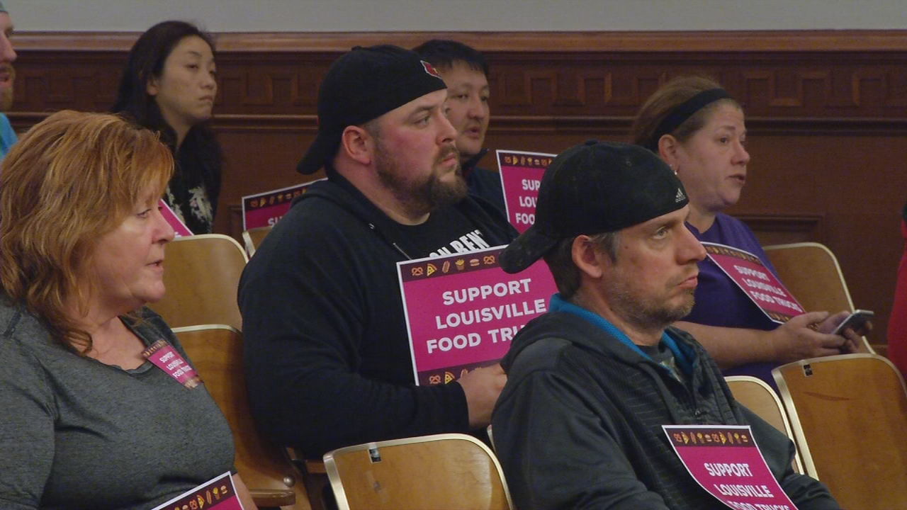 Supporters of food truck businesses brought signs to the June 4, 2019 Louisville Metro Council meeting